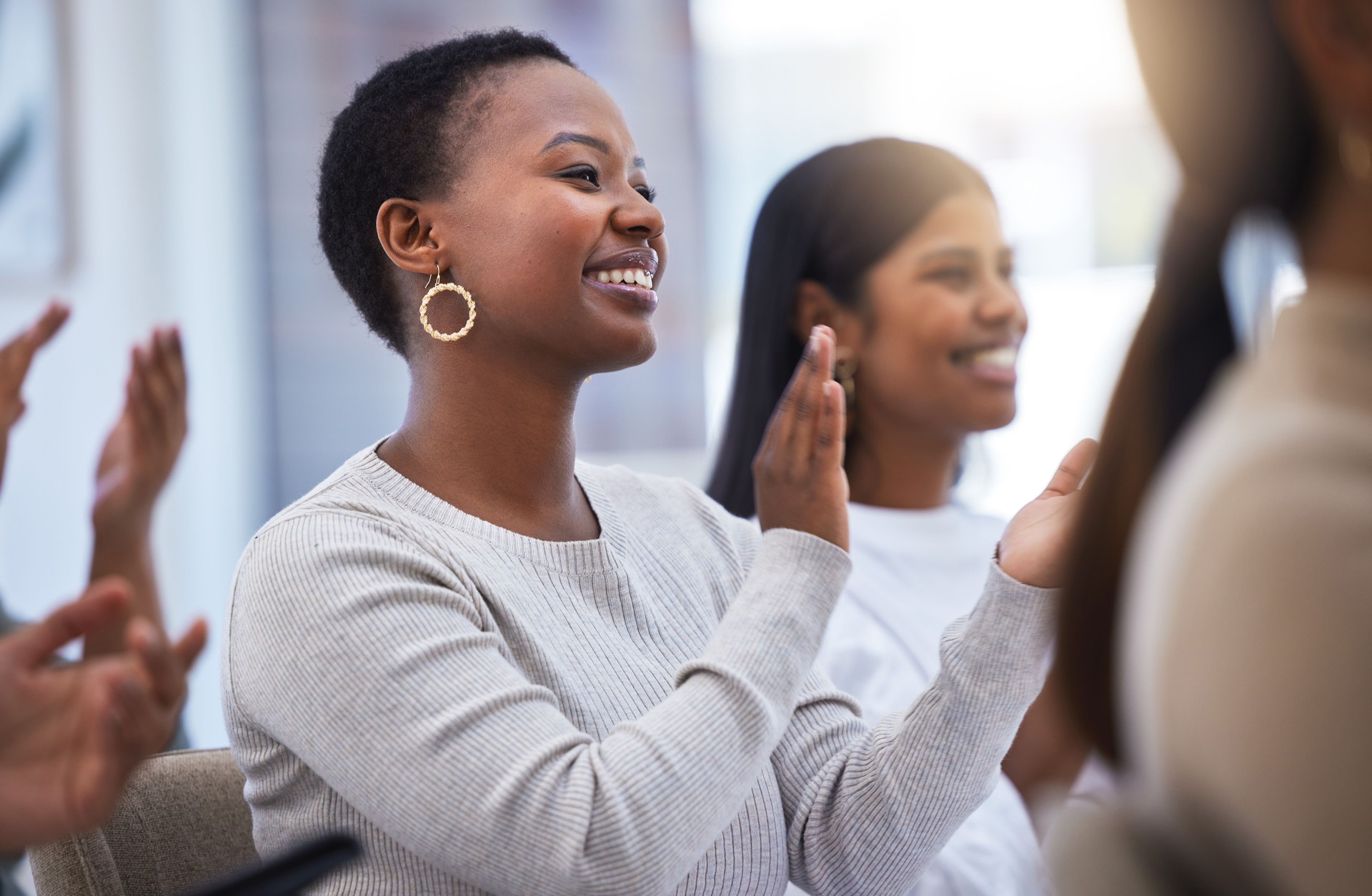 Shot of a group of people clapping and smiling during a meeting at work